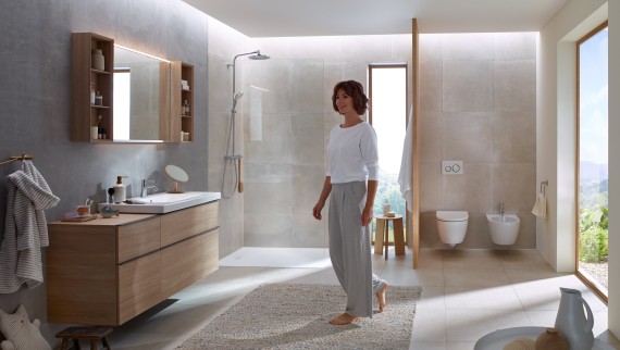 Woman in a bathroom featuring the Geberit iCon bathroom series