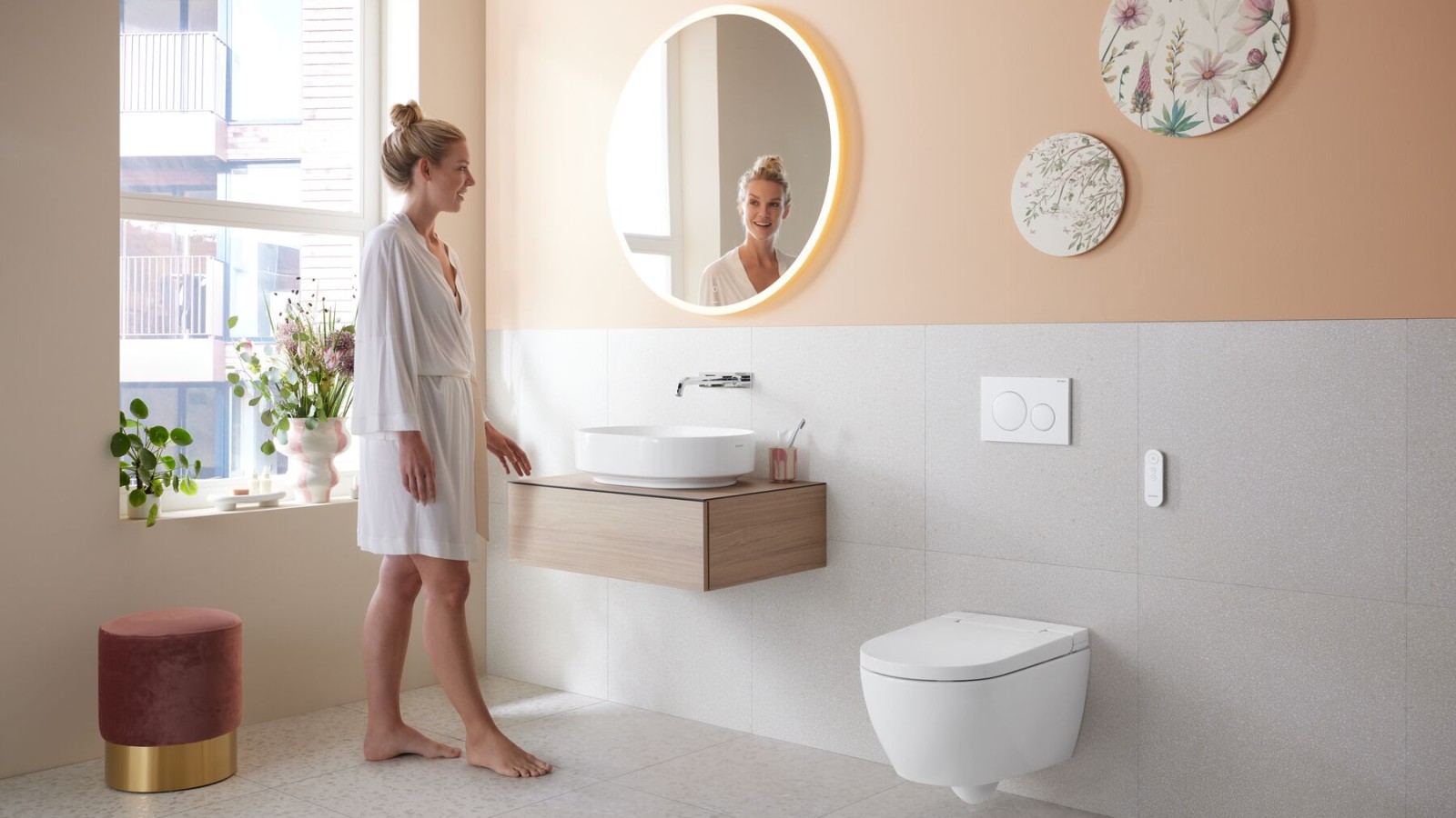 Woman in Geberit Acanto bathroom with wall-mounted toilet