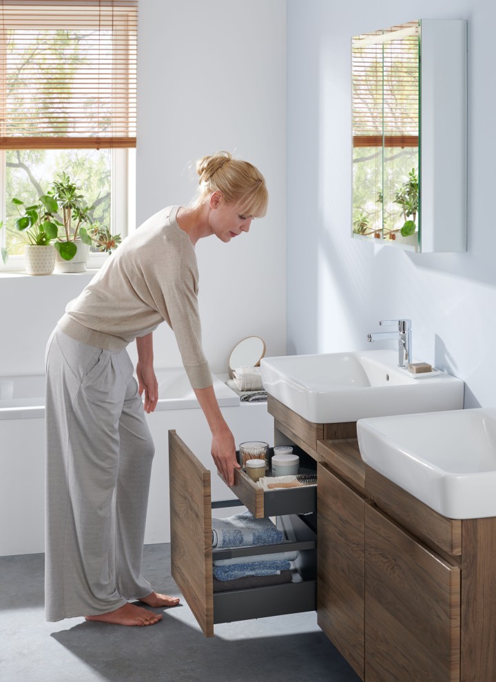 Woman in white bathroom from the Geberit Renova Plan bathroom series