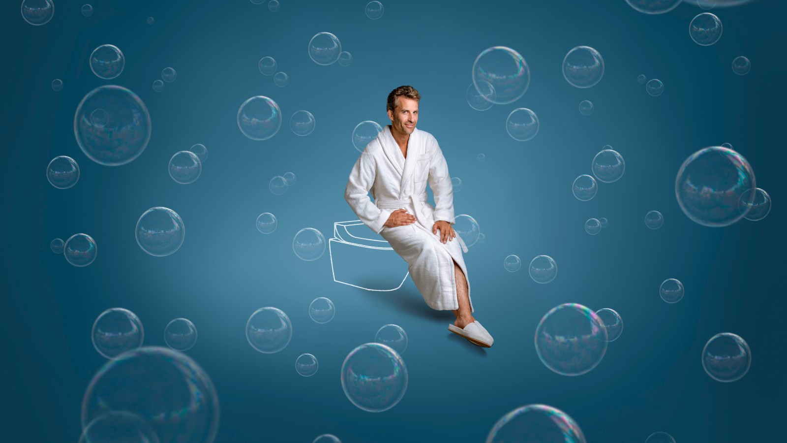 Tim sitting on Geberit AquaClean Tuma shower toilet