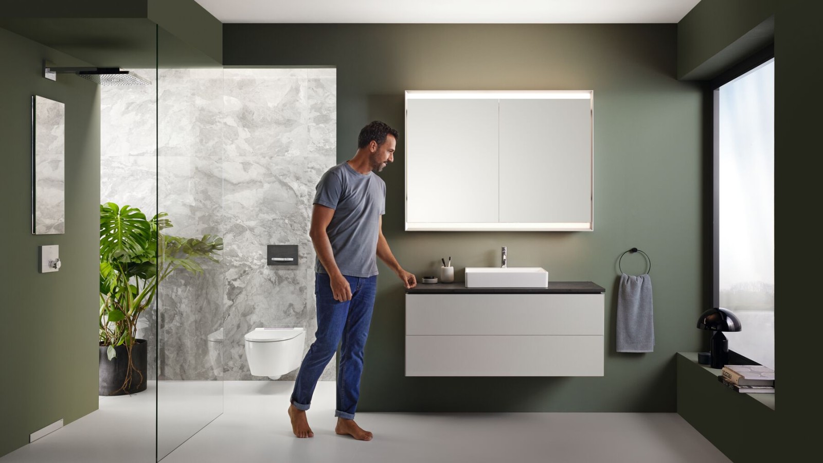 Man in a Geberit bathroom with a walk-in shower