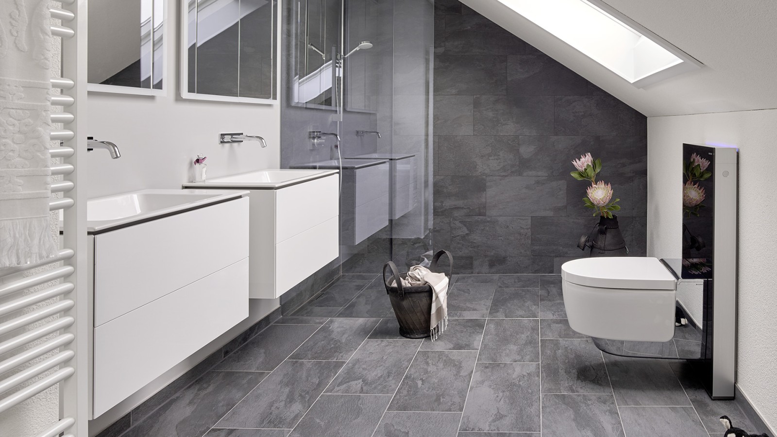 Bathroom with sloping roof and products from the Geberit ONE bathroom series and Geberit AquaClean with Monolith